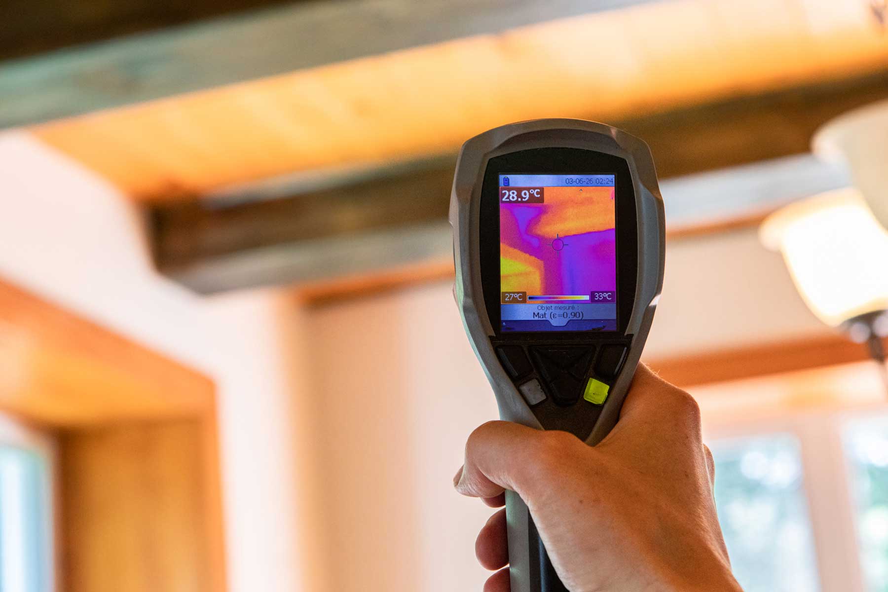 Billings inspector scanning a ceiling with an infrared camera