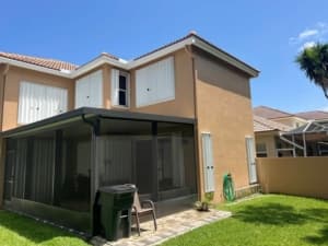 Home fitted with hurricane shutters for wind mitigation